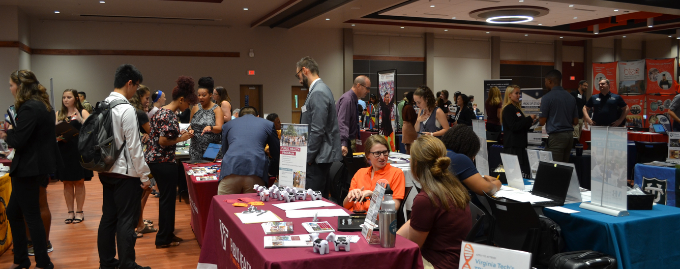 gpsf 2023 students gathered at tables at grad fair