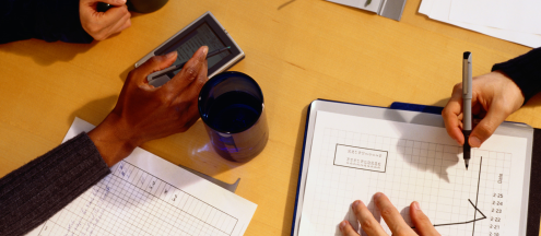 image from above of people working on various business items